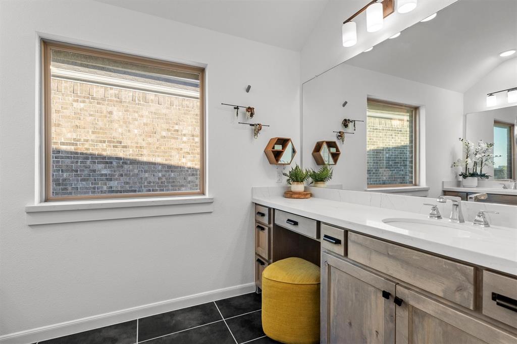 813 Forest Lake Road Flower Mound, TX 75028 - Photo 22 of 39 a bathroom with a granite countertop sink a toilet and a window