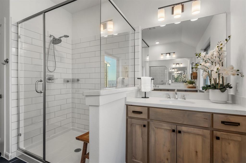 813 Forest Lake Road Flower Mound, TX 75028 - Photo 23 of 39 a bathroom with a shower sink and mirror