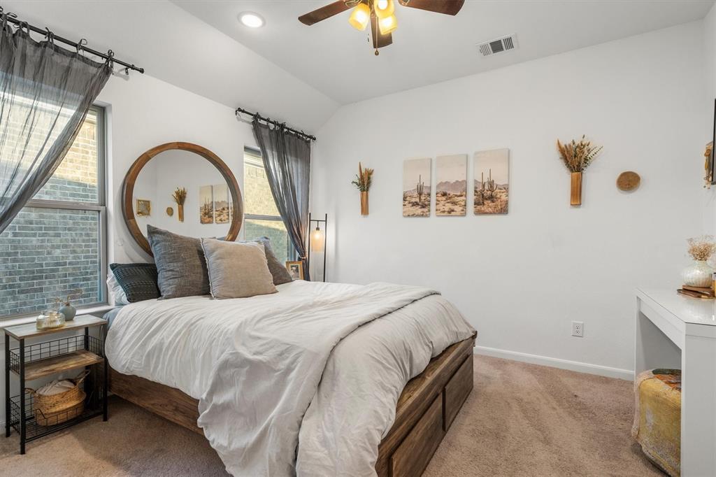813 Forest Lake Road Flower Mound, TX 75028 - Photo 24 of 39 a bedroom with a bed and a chandelier
