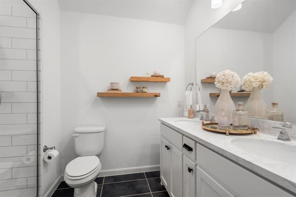 813 Forest Lake Road Flower Mound, TX 75028 - Photo 25 of 39 a bathroom with a toilet sink and mirror