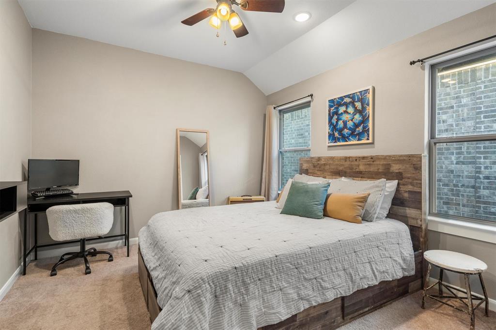 813 Forest Lake Road Flower Mound, TX 75028 - Photo 26 of 39 a bedroom with a large bed and a desk