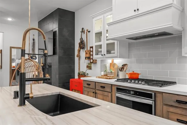 a kitchen with stainless steel appliances kitchen island granite countertop a sink and cabinets