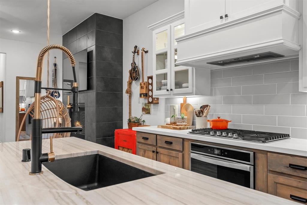 813 Forest Lake Road Flower Mound, TX 75028 - Photo 7 of 39 a kitchen with stainless steel appliances kitchen island granite countertop a sink and cabinets