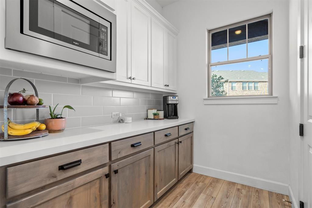 813 Forest Lake Road Flower Mound, TX 75028 - Photo 8 of 39 a kitchen with stainless steel appliances granite countertop a sink and wooden cabinets