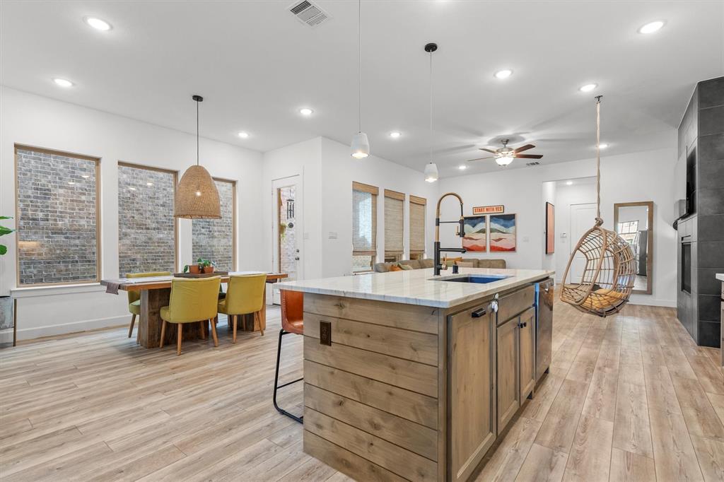 813 Forest Lake Road Flower Mound, TX 75028 - Photo 9 of 39 a kitchen with a stove and a wooden floor