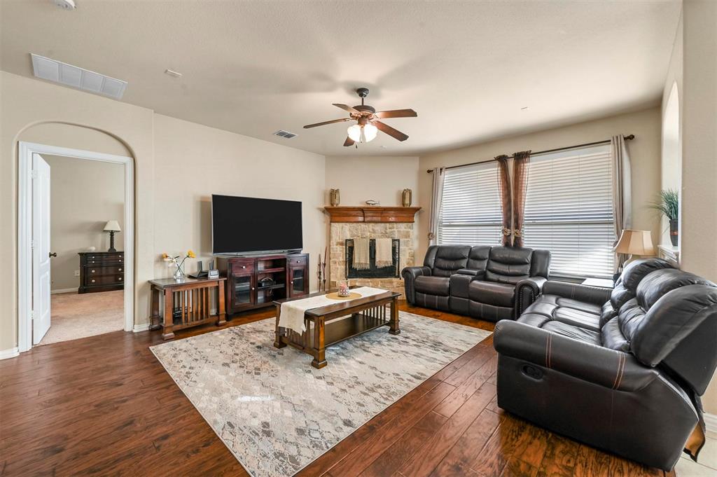 14815 Frisco Ranch Drive Little Elm, TX 75068 - Photo 10 of 40 Beautiful stone fireplace, beautiful wood floors and tons of natural light in the living room!