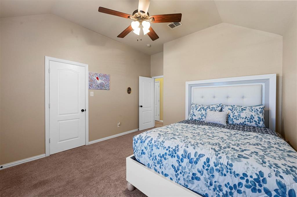 14815 Frisco Ranch Drive Little Elm, TX 75068 - Photo 31 of 40 Upstairs bedroom #4 with a primary bedroom sized closet.