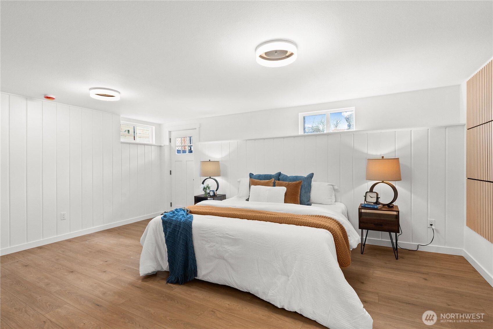 1811 South Stevens Street Seattle, WA 98144 - Photo 28 of 38 a bedroom with a bed and wooden floor