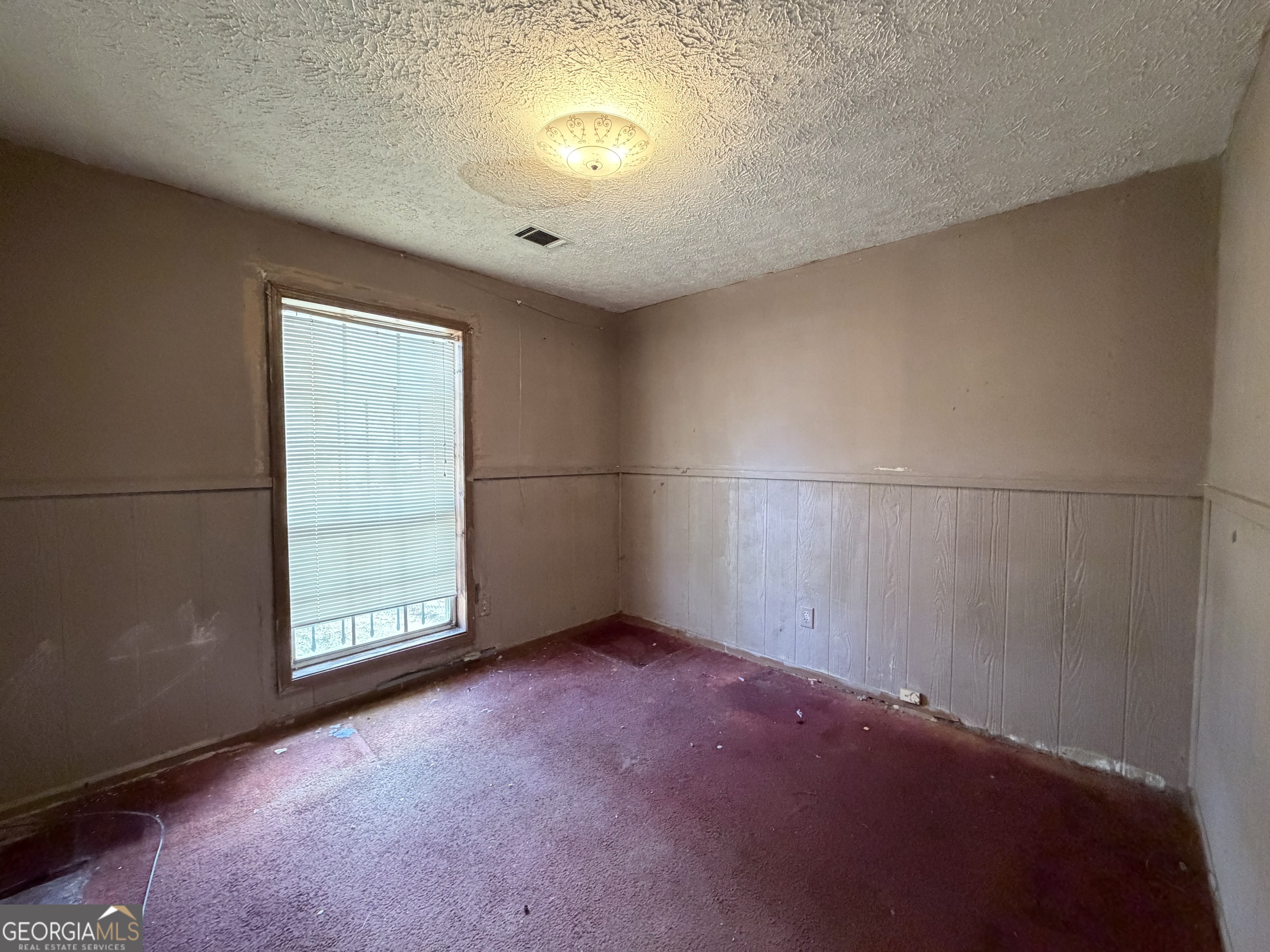 7118 Pineneedle Drive Southwest Covington, GA 30014 - Photo 12 of 17 an empty room with a empty space and windows
