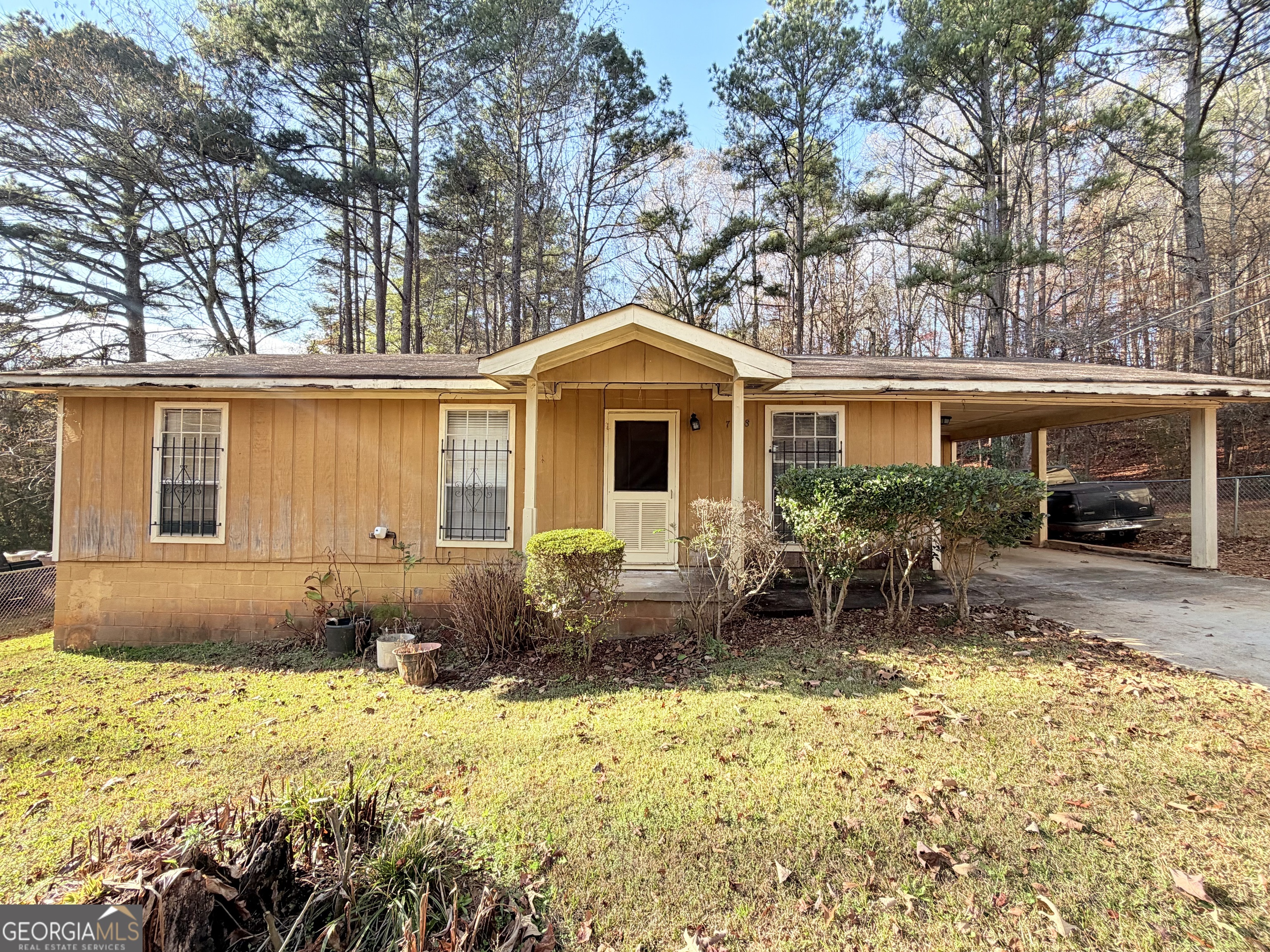7118 Pineneedle Drive Southwest Covington, GA 30014 - Photo 14 of 17 a front view of a house with a yard and outdoor seating