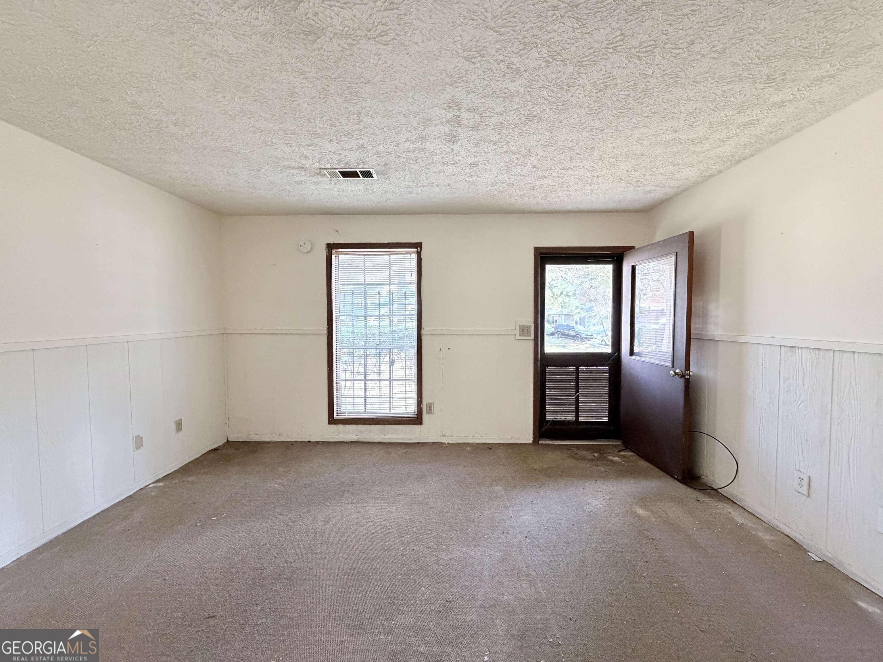 7118 Pineneedle Drive Southwest Covington, GA 30014 - Photo 4 of 17 an empty room with windows