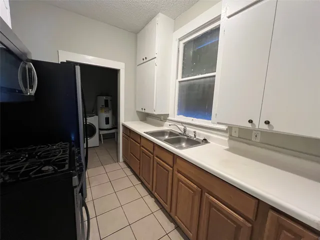 a kitchen with a sink stove and refrigerator