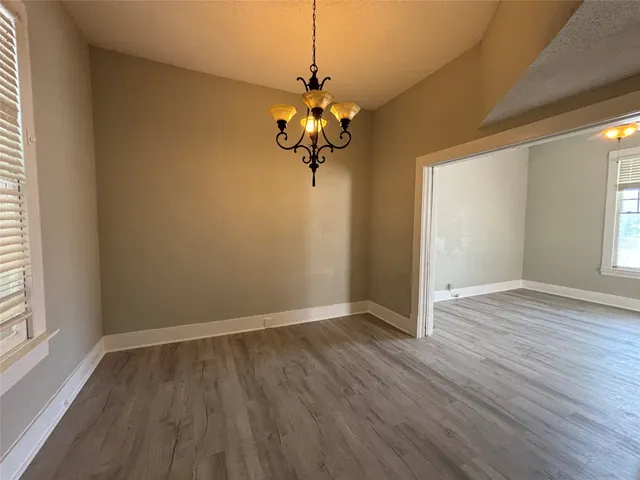 a view of a room with wooden floor