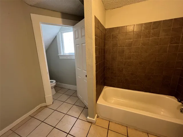 a bathroom with a bathtub and a toilet