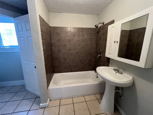 a bathroom with a sink a mirror and a bathtub