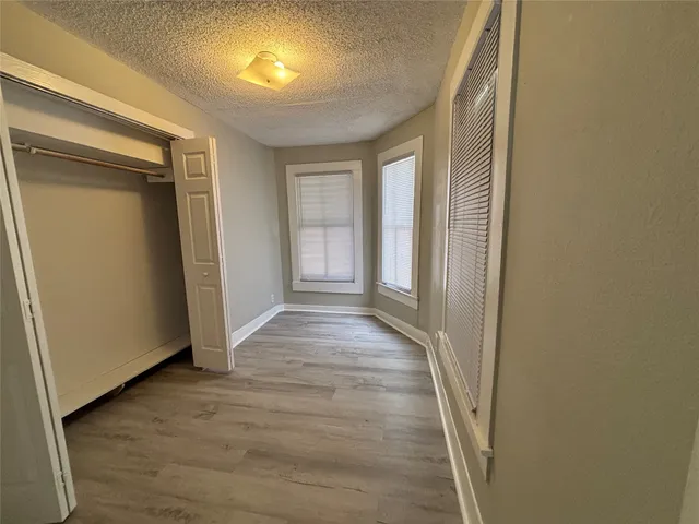 a view of a room with wooden floor and windows