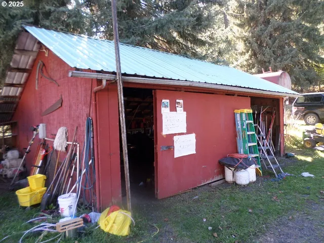 a view of a chair and table in backyard of the house