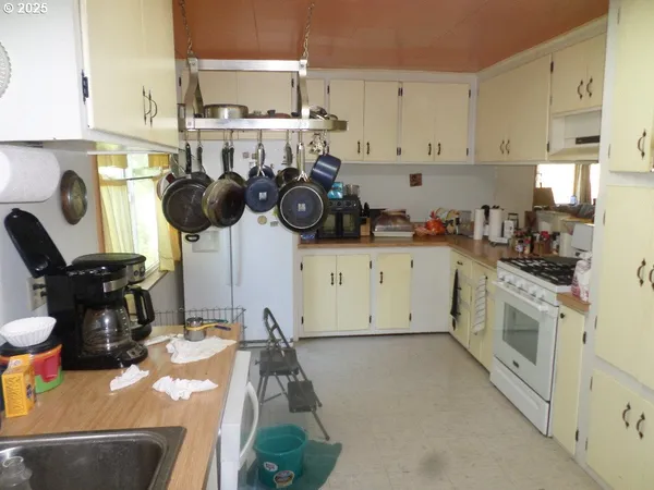 a kitchen with a sink appliances and cabinets