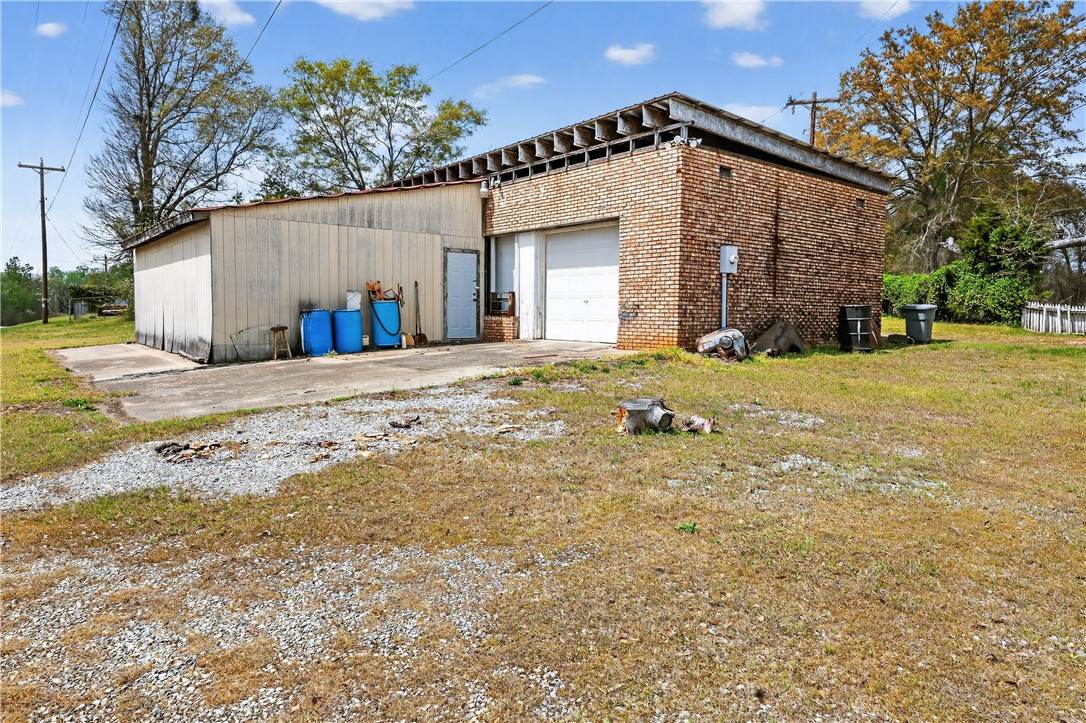 155 Farrs Bridge Road Pickens, SC 29671 - Photo 17 of 19 This property features a brick building with a garage, offering practical space for various needs.