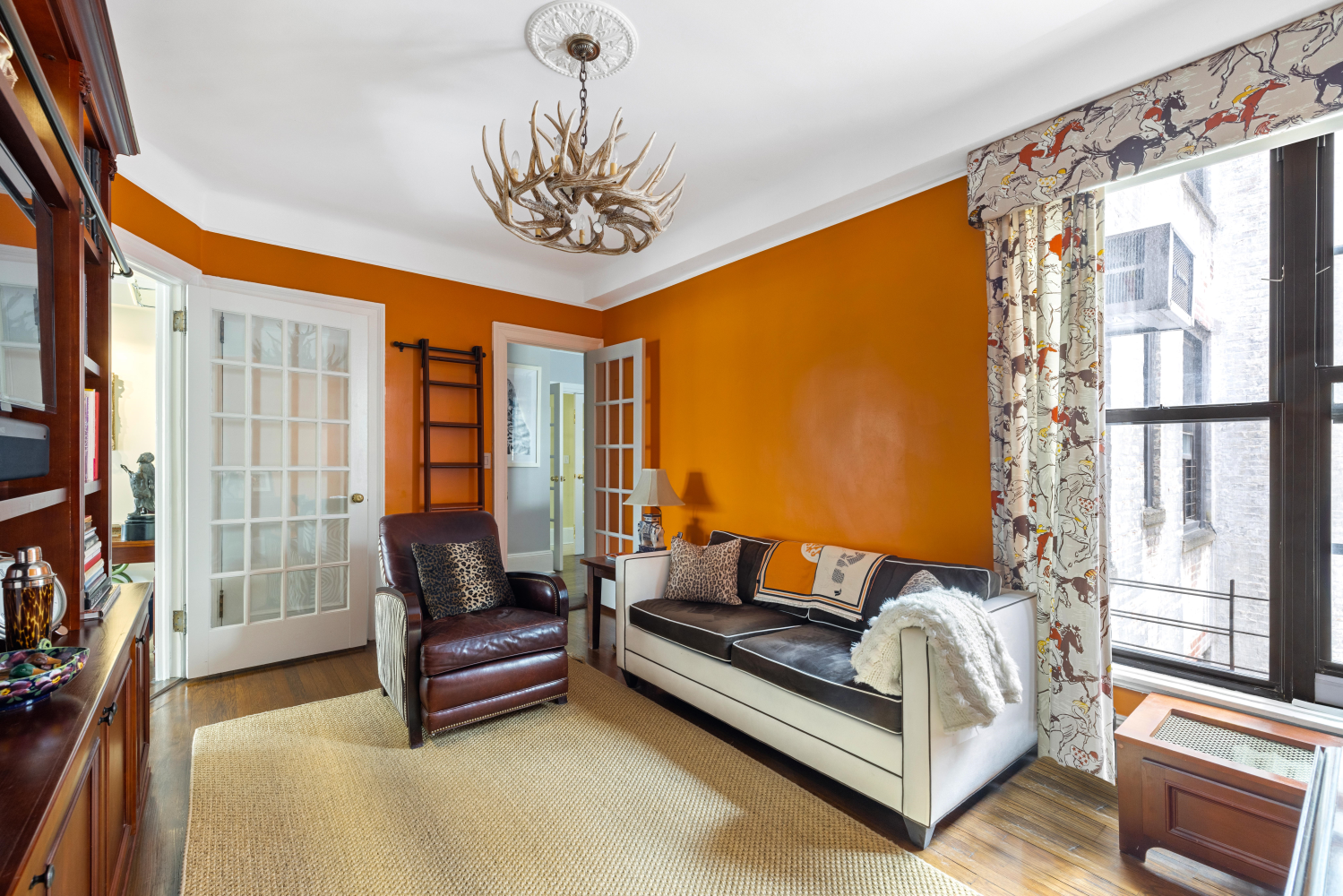 114 East 84th Street, Unit 8B Manhattan, NY 10028 - Photo 9 of 15 a bedroom with furniture and a large window