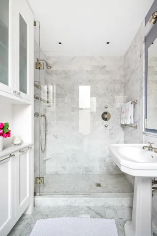 a bathroom with a toilet sink a mirror a bathtub and shower