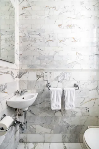 a bathroom with a sink shower and a mirror
