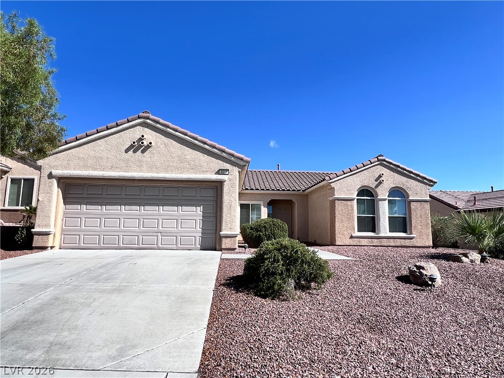 3047 Hickory Valley Road Henderson, NV 89052 - Photo 30 of 33 A terracotta-tiled roof crowns this charming desert residence with well-maintained landscaping.
