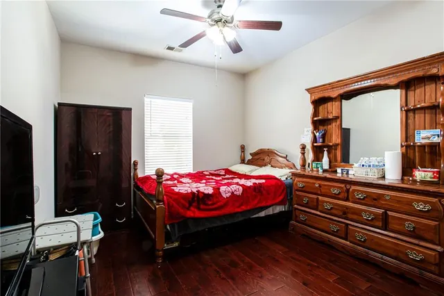 a bedroom with a bed and wooden floor