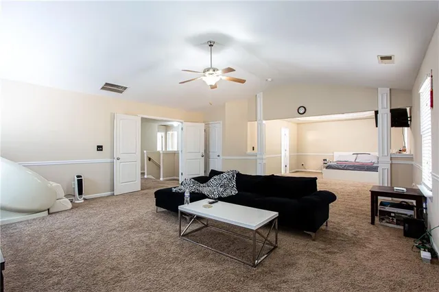 a living room with furniture and a chandelier