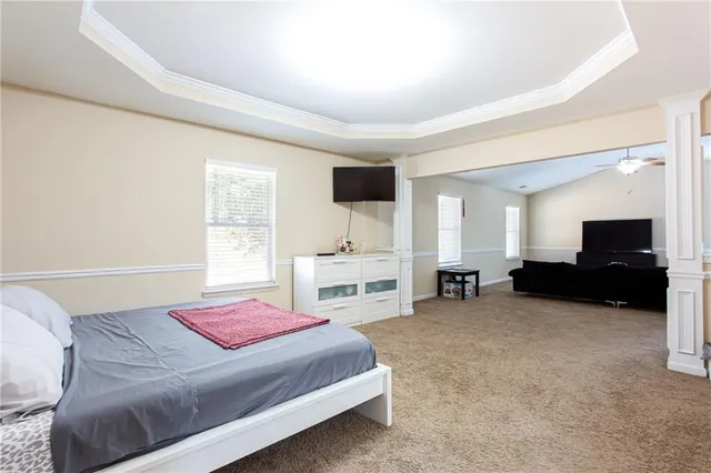 a bedroom with a bed and a chair