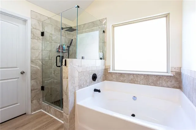 a bathroom with a bathtub and a shower