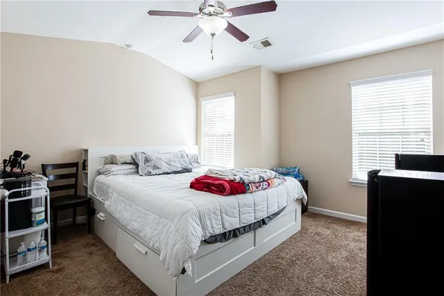 a bedroom with a bed and window