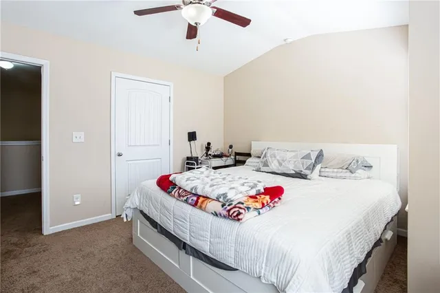 a bedroom with bed and a chandelier
