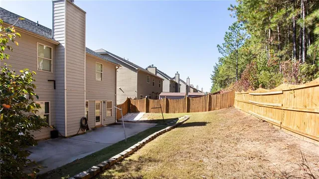 a view of a house with wooden fence