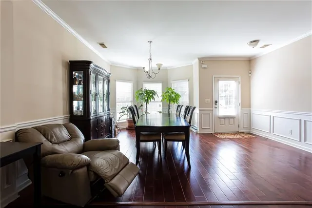 a living room with furniture dining table and a chandelier