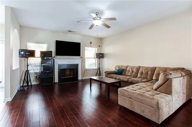 a living room with furniture fireplace and flat screen tv