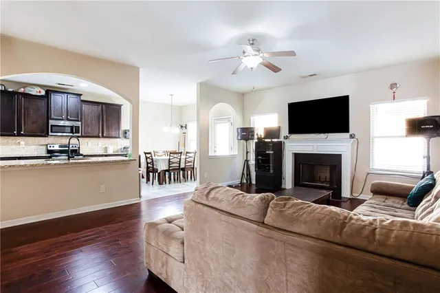 a living room with furniture a fireplace and a flat screen tv
