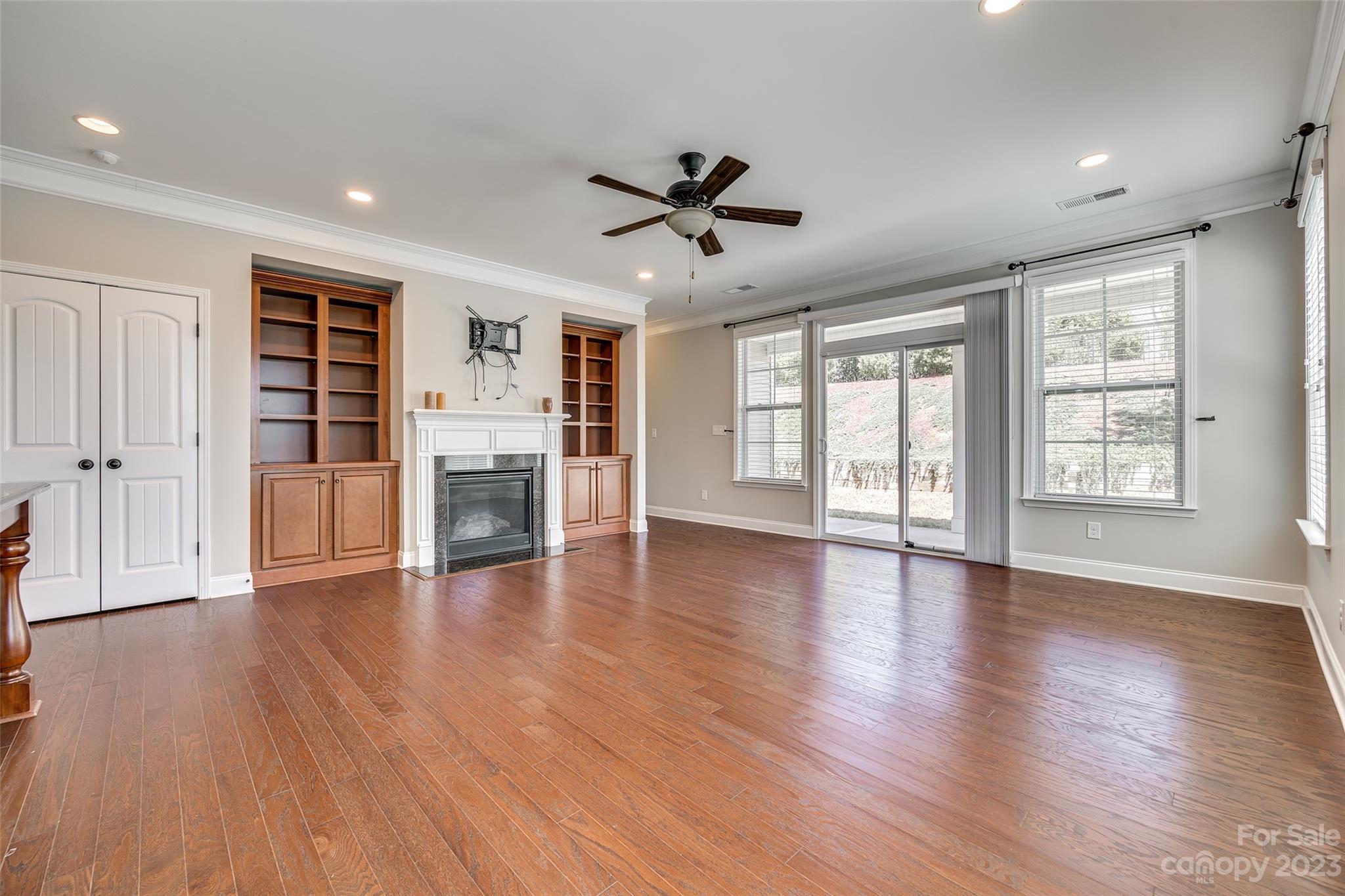 198 Annatto Way Tega Cay, SC 29708 - Photo 15 of 45 a view of an empty room with a window and wooden floor