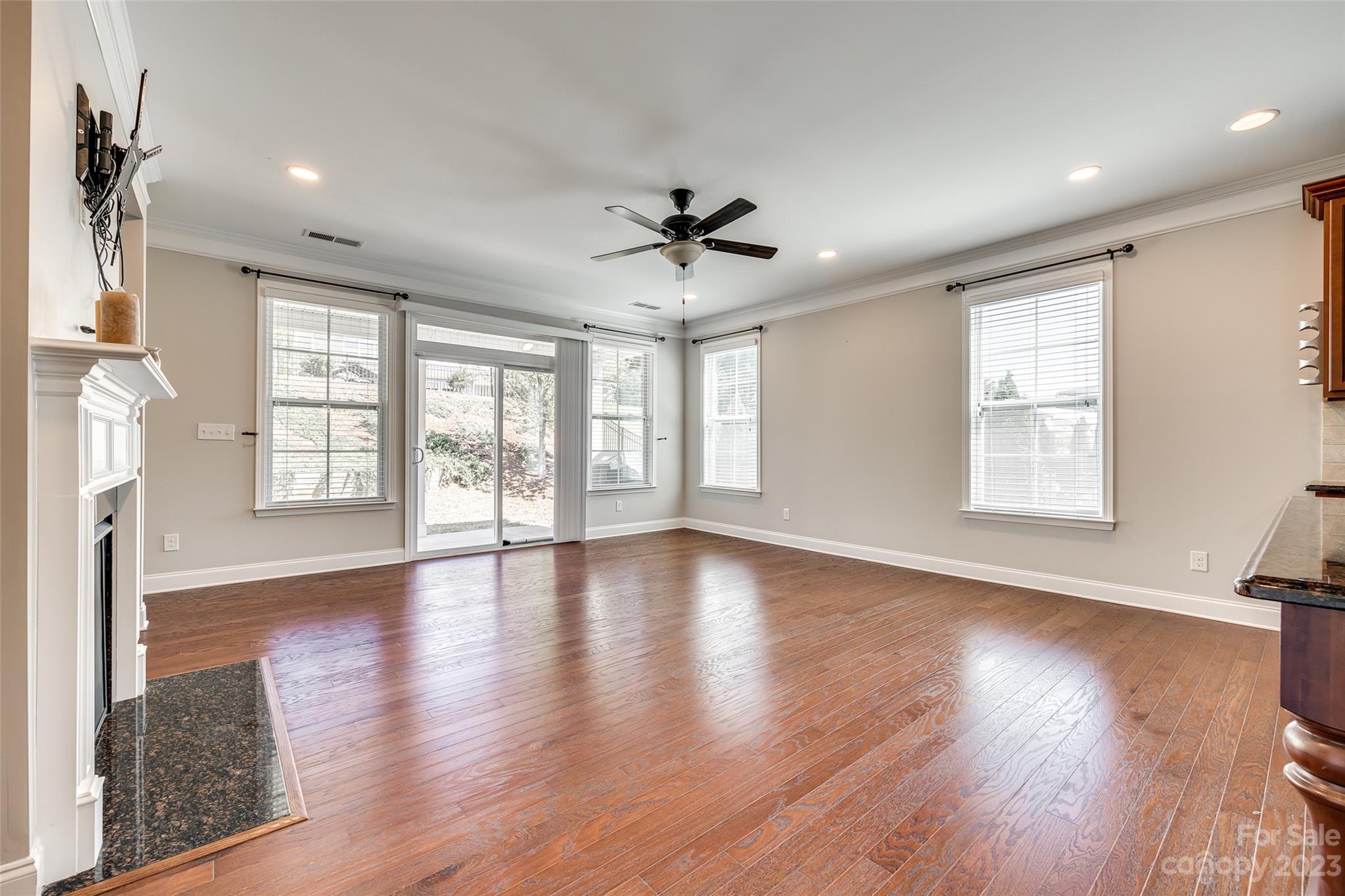 198 Annatto Way Tega Cay, SC 29708 - Photo 16 of 45 a view of an empty room with wooden floor and a window