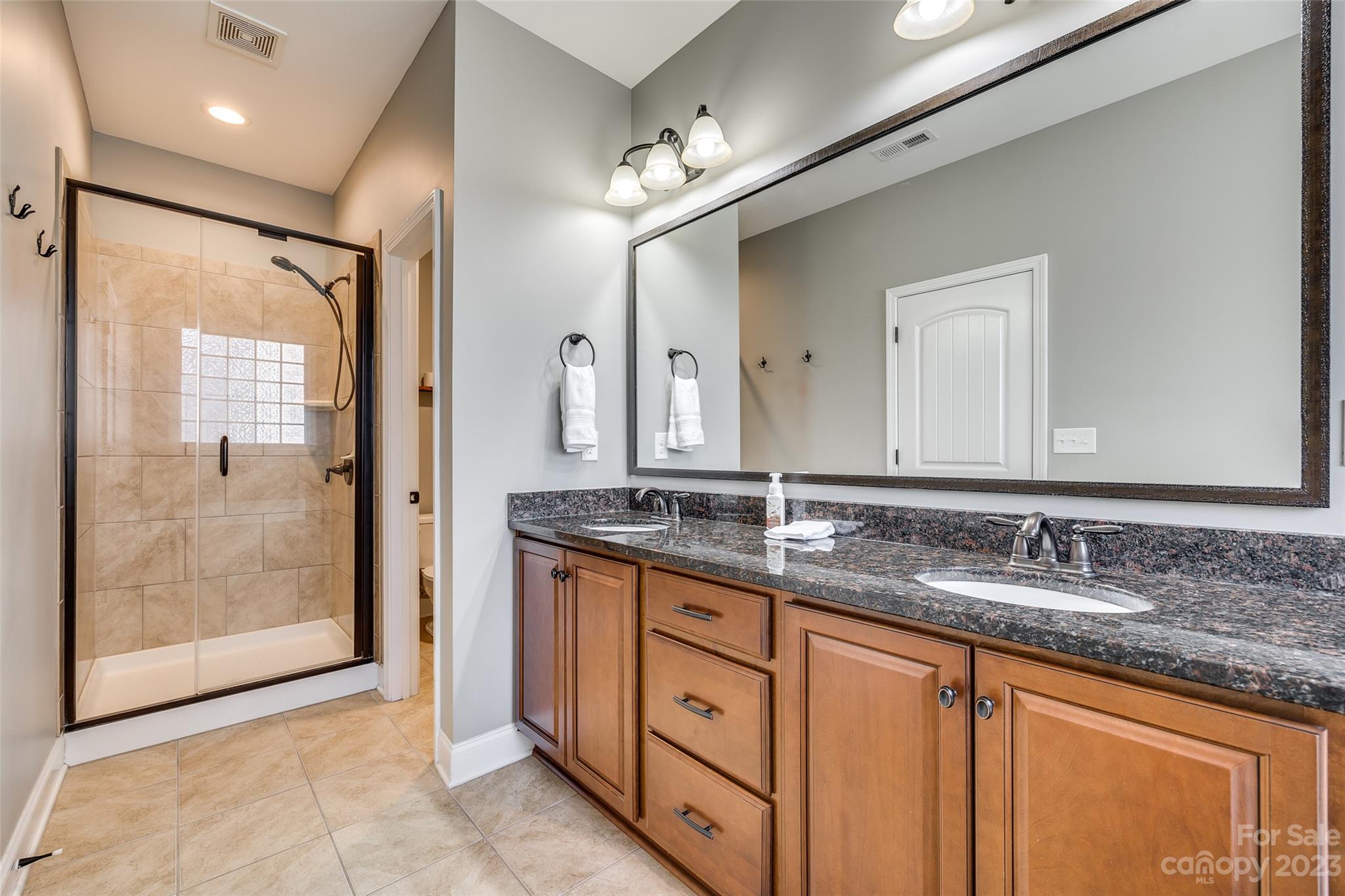 198 Annatto Way Tega Cay, SC 29708 - Photo 26 of 45 a bathroom with double sink and a mirror