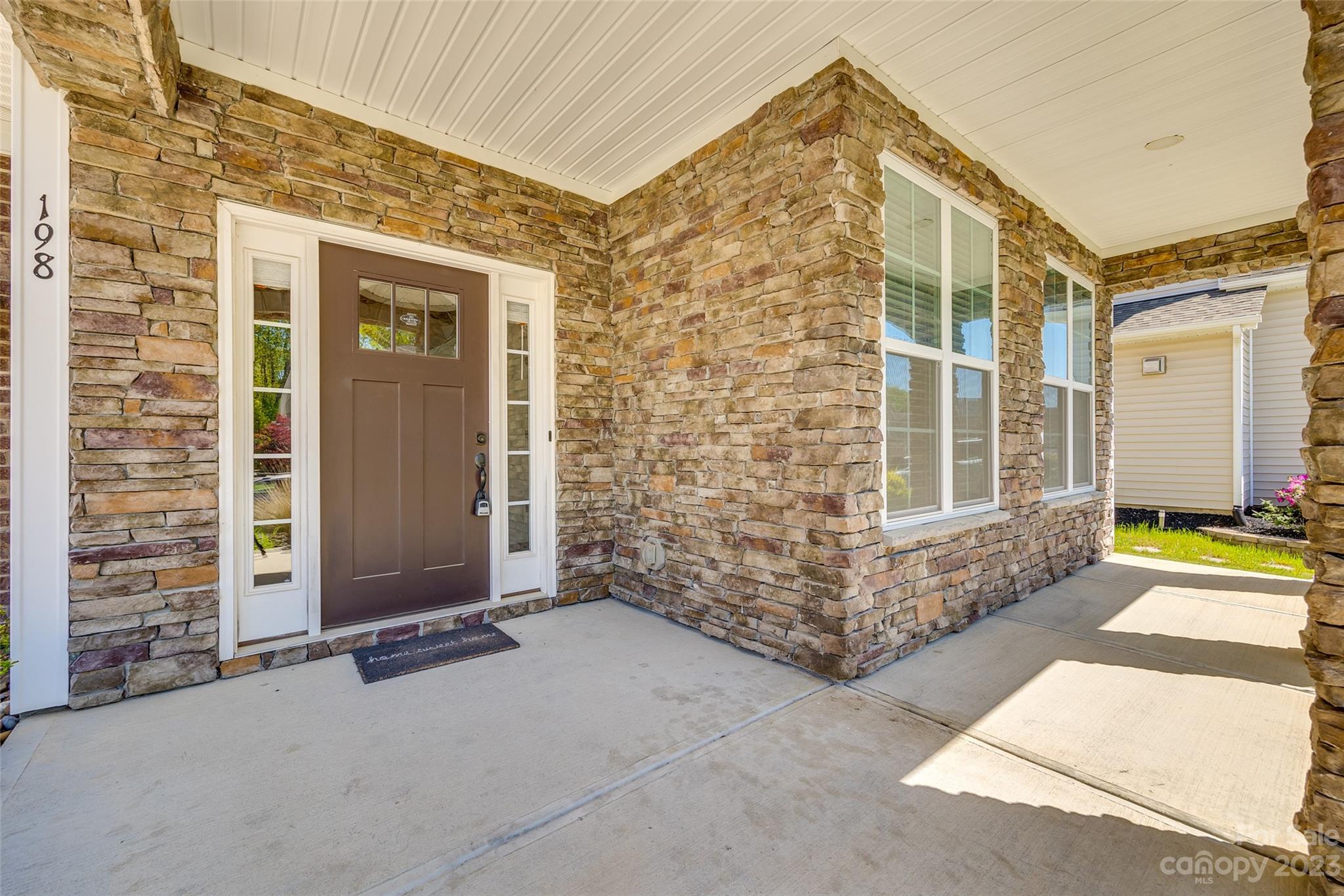 198 Annatto Way Tega Cay, SC 29708 - Photo 3 of 45 front view of a brick house with a outdoor space