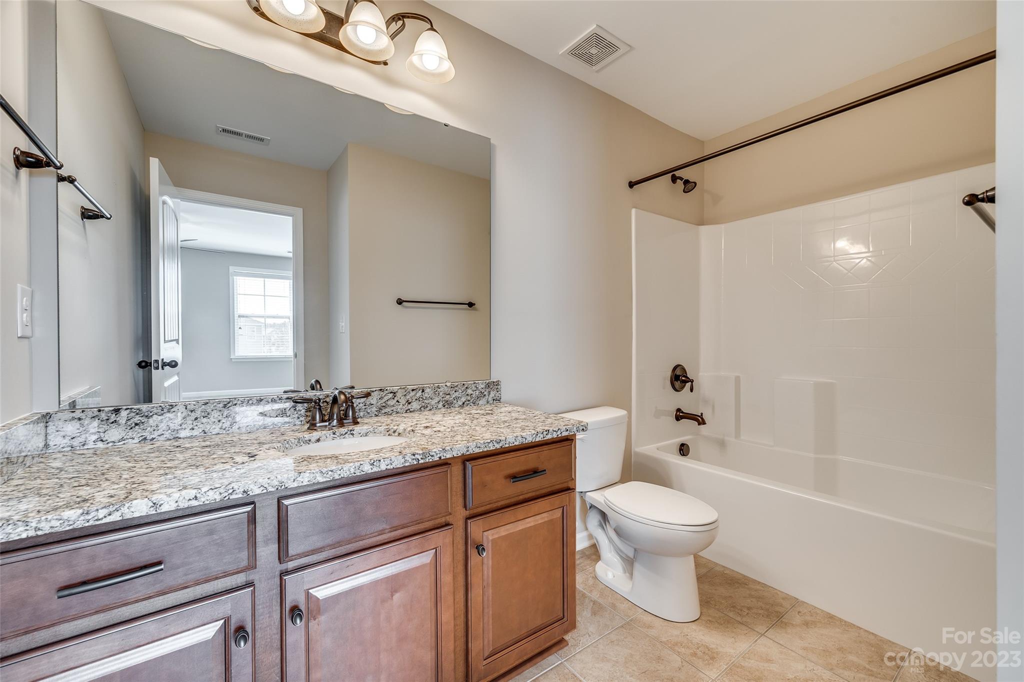 198 Annatto Way Tega Cay, SC 29708 - Photo 31 of 45 a bathroom with a granite countertop sink a toilet and shower