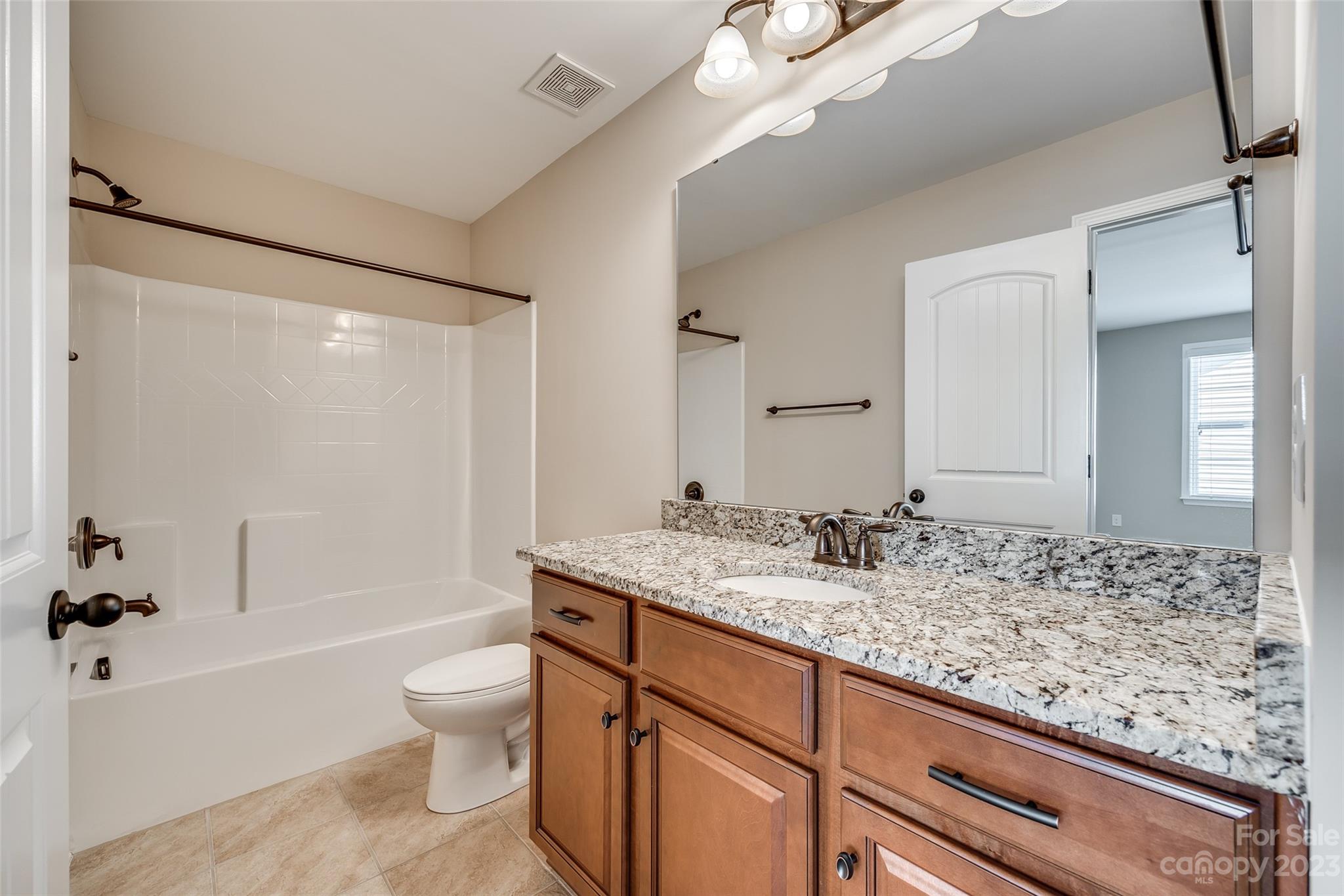 198 Annatto Way Tega Cay, SC 29708 - Photo 34 of 45 a bathroom with a granite countertop sink mirror toilet and bathtub