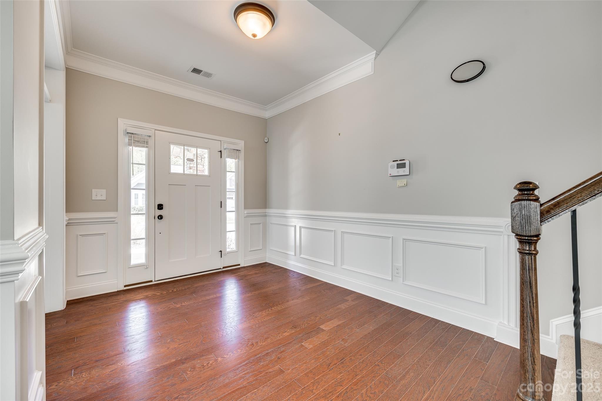 198 Annatto Way Tega Cay, SC 29708 - Photo 4 of 45 a view of an empty room with wooden floor and a window