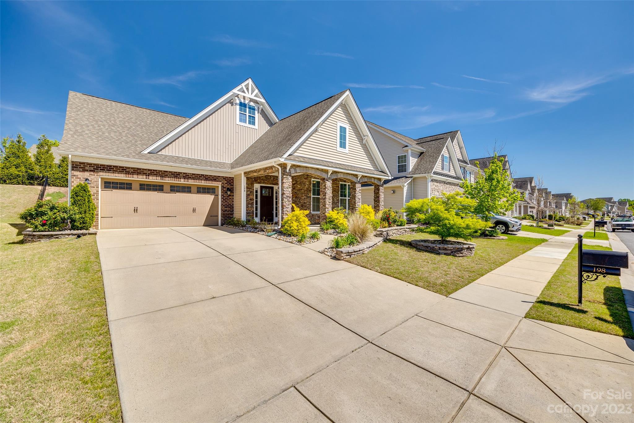 198 Annatto Way Tega Cay, SC 29708 - Photo 42 of 45 a view of a white house with a large windows next to a yard