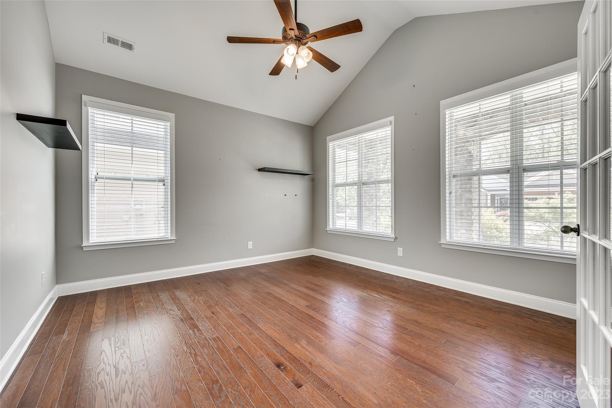 198 Annatto Way Tega Cay, SC 29708 - Photo 6 of 45 a view of an empty room with wooden floor and a window