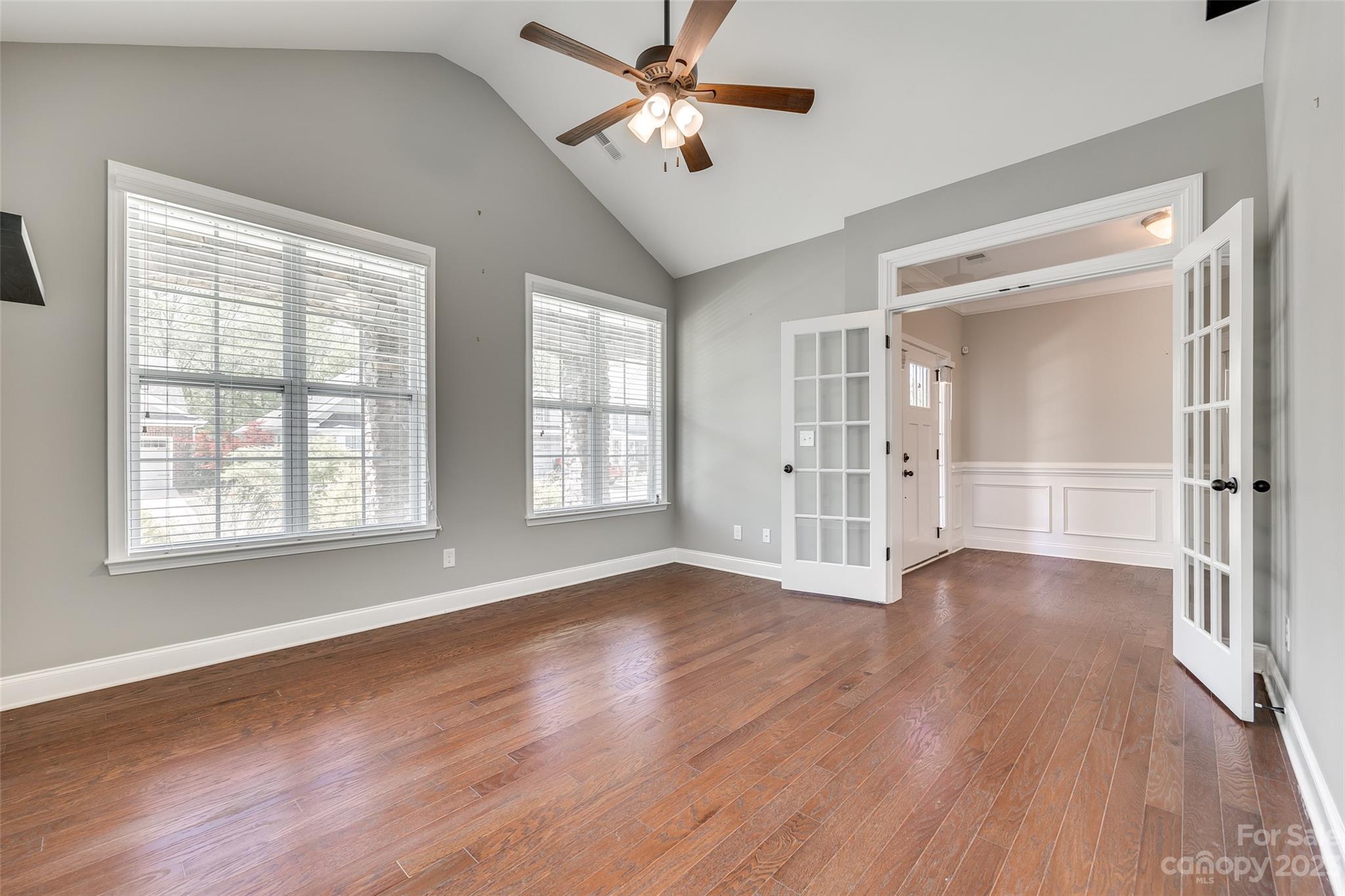 198 Annatto Way Tega Cay, SC 29708 - Photo 7 of 45 a view of an empty room with wooden floor and a window