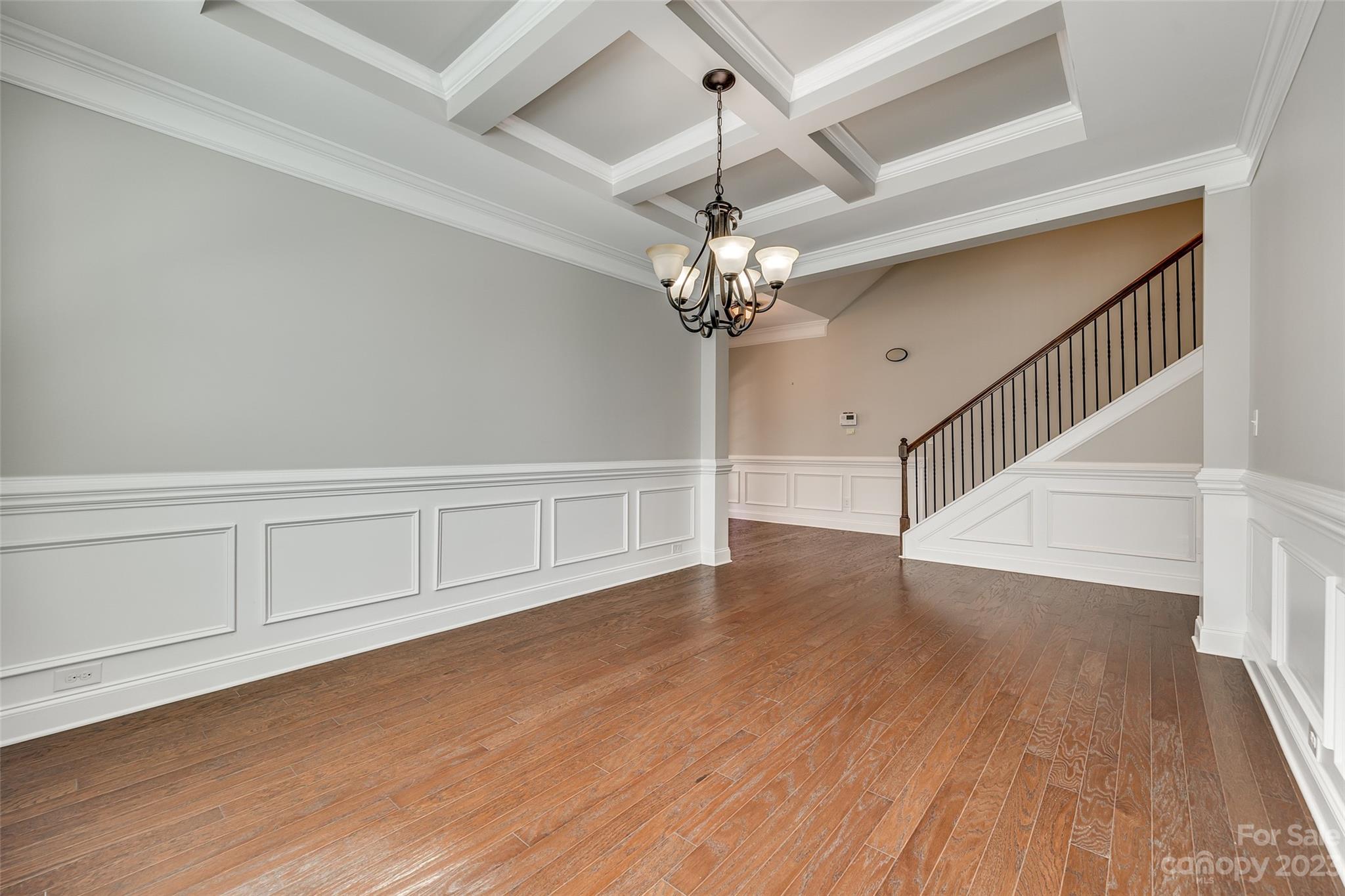 198 Annatto Way Tega Cay, SC 29708 - Photo 10 of 45 wooden floor in an empty room with a chandelier