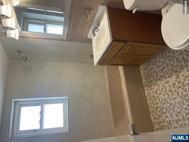 279 Chestnut Street Nutley, NJ 07110 - Photo 7 of 9 a bathroom with a sink a toilet and shower