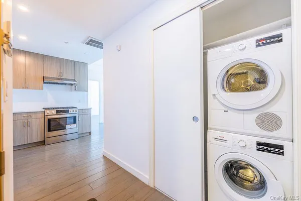 a kitchen with granite countertop wooden floors and stainless steel appliances